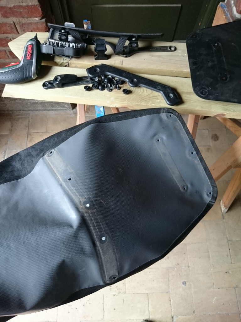 With all screws and fittings removed, the pannier is turned inside-out before the patch is added.